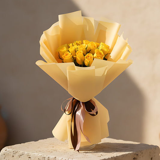 Hand-tied bouquet of 15 fresh yellow roses wrapped in elegant gold paper