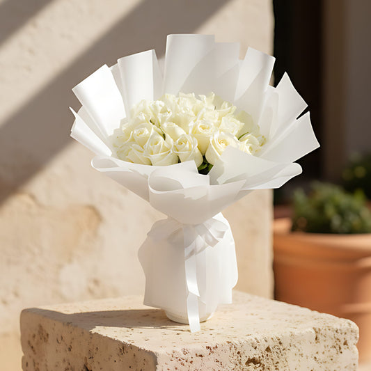 Hand-tied bouquet of 25 fresh white roses wrapped in elegant white paper