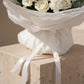 Close-up detail of white bouquet wrapping and ribbon on Pure Intention flower arrangement.