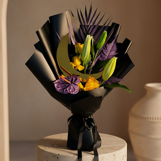 Luxury Ramadan hand-tied bouquet with yellow roses, purple anthurium, a lily stem, fresh greenery, and a moon-shaped topper in elegant black wrapping, available for delivery in Dubai.