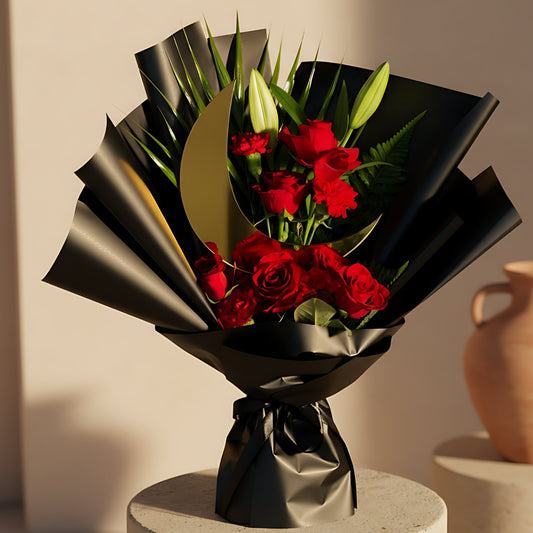 Luxury Ramadan hand-tied bouquet with red roses, red carnations, lily stem, greenery, and a moon-shaped topper, elegantly wrapped for delivery in Dubai.