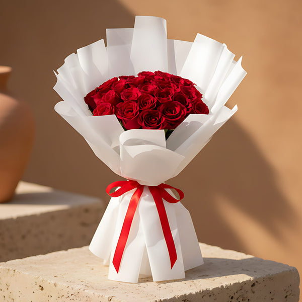 Hand-tied bouquet of 25 fresh red roses wrapped in elegant white paper