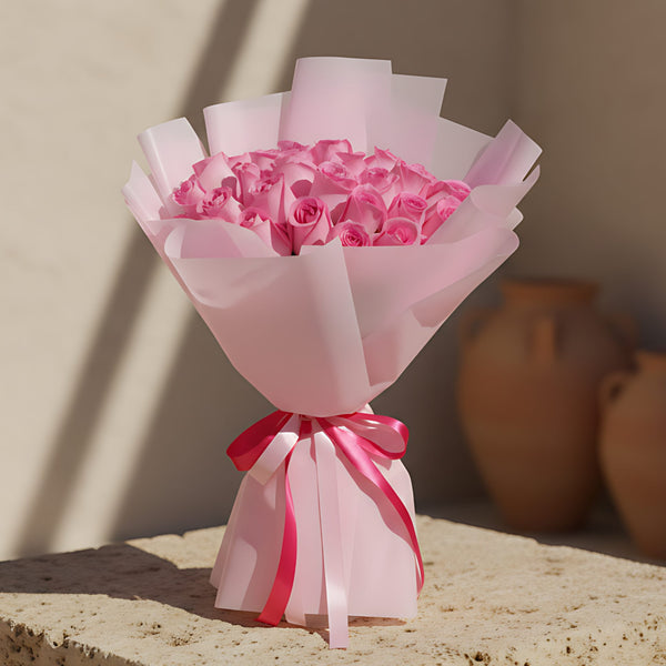 Hand-tied bouquet of 25 fresh pink roses wrapped in soft light pink paper