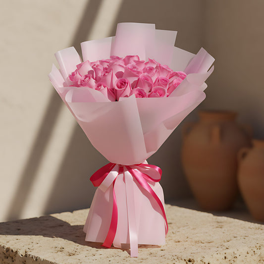 Hand-tied bouquet of 25 fresh pink roses wrapped in soft light pink paper