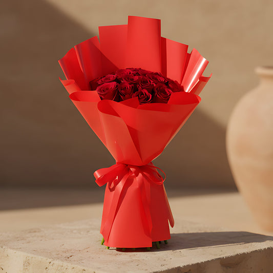 Hand-tied bouquet of 15 fresh red roses wrapped in elegant red paper