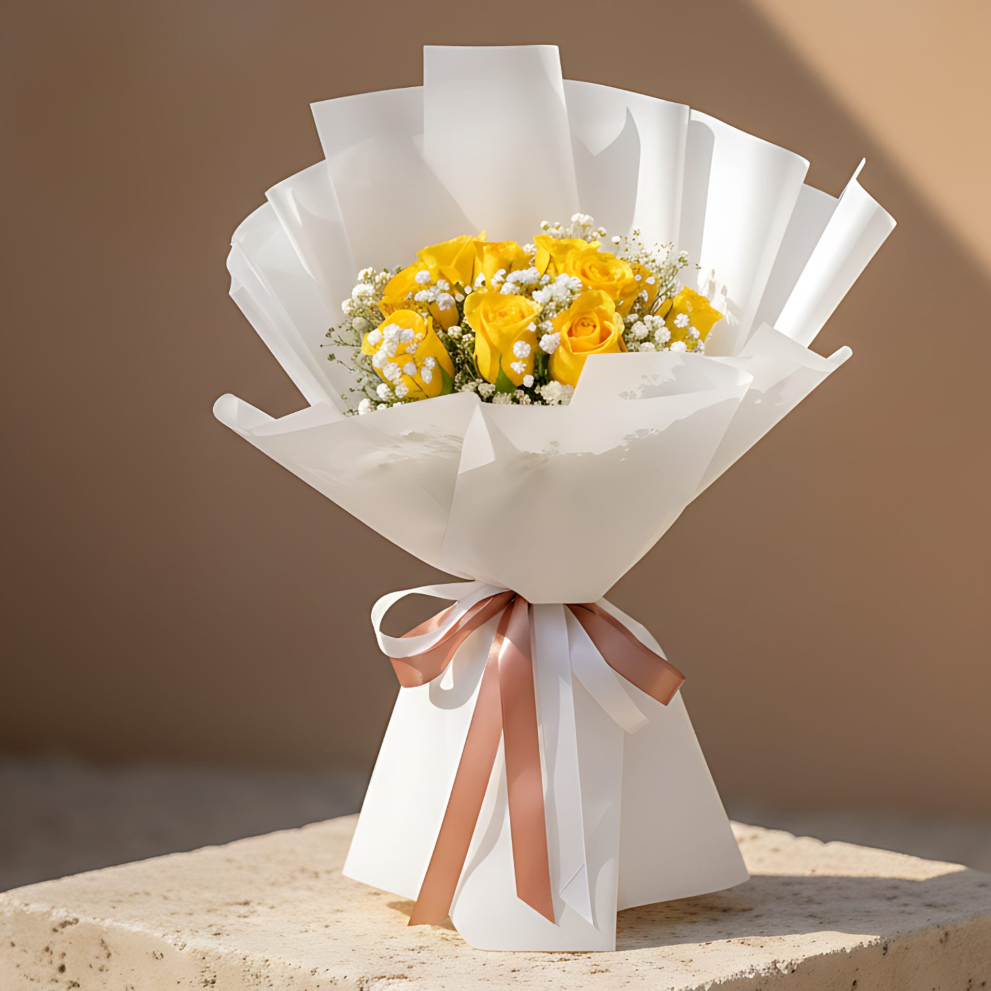 Hand-tied bouquet of 10 yellow roses with delicate gypsophila wrapped in elegant white paper