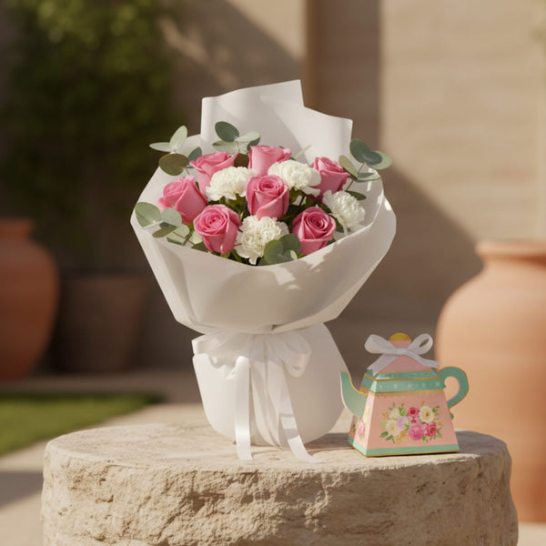 Tea With You bouquet with pink roses, white carnations and eucalyptus styled with decorative tea-pot gift box.