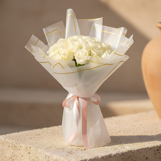 Hand-tied bouquet of 25 fresh white roses wrapped in modern trendy paper