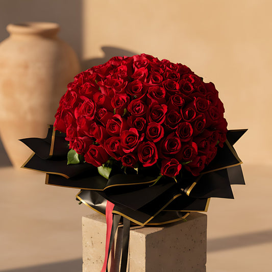 Hand-tied bouquet of 155 fresh red roses wrapped in elegant black paper