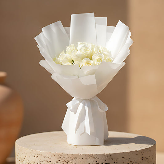 Hand-tied bouquet of 15 fresh white roses wrapped in elegant white paper