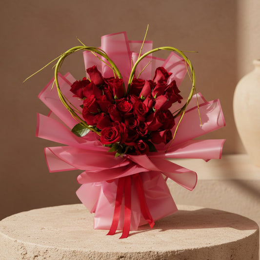 Amour Charm hand-tied bouquet with 35 red roses in heart-shaped design and red wrapping by Aiwa Flowers