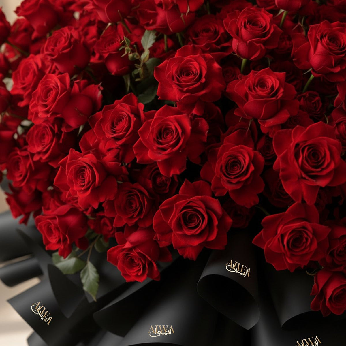 Detail of a grand red rose bouquet with black AIWA wrapping by AIWA Flowers