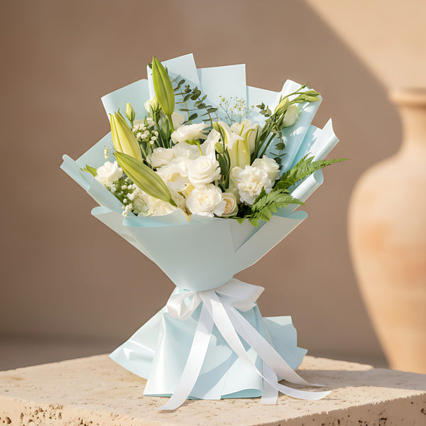 Baby Blue hand-tied bouquet with white lilies, roses, carnations, hydrangea and light blue wrapping by Aiwa Flowers