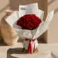 Red rose bouquet in white wrapping with red ribbon by AIWA Flowers Dubai