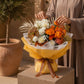 Woman holding an orange and white rose bouquet by AIWA Flowers Dubai