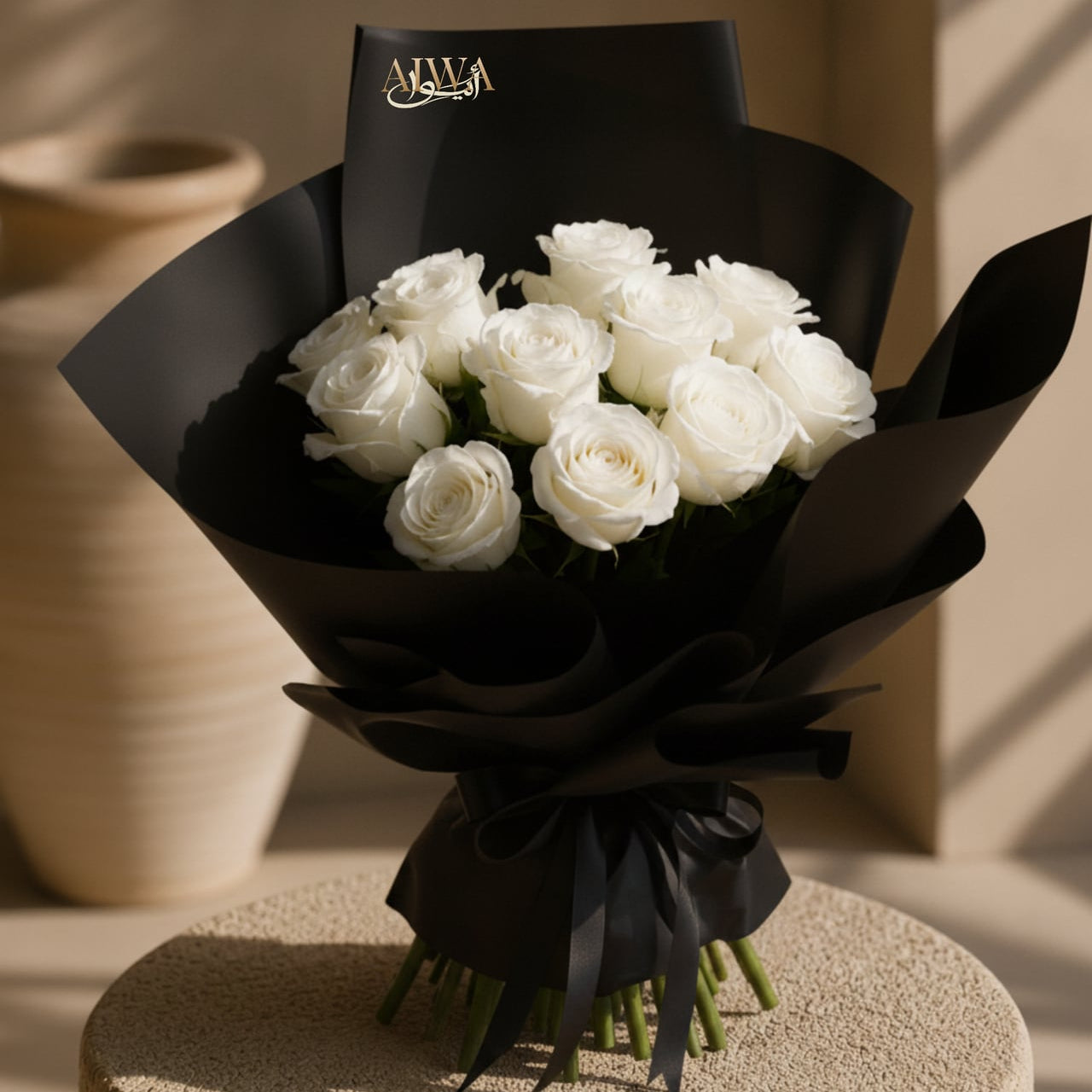White rose bouquet in elegant black wrapping by AIWA Flowers Dubai