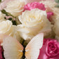 Close-up of white and pink roses with a butterfly accent by AIWA Flowers Dubai