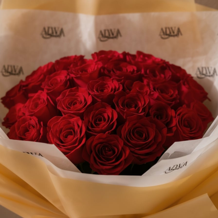 Close-up of red roses in gold wrapping by AIWA Flowers Dubai