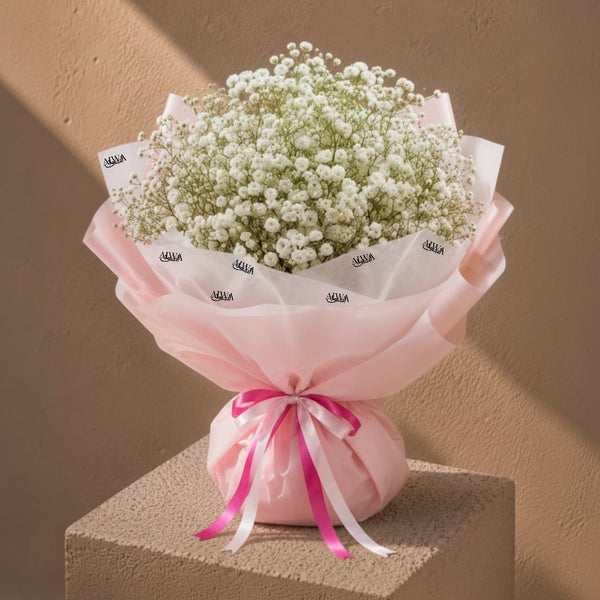 White gypsophila bouquet in pink wrap by AIWA Flowers Dubai