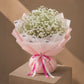 White gypsophila bouquet in pink wrap by AIWA Flowers Dubai