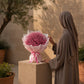 Woman holding a pink gypsophila bouquet by AIWA Flowers Dubai