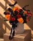 Creeper Halloween flower box of orange, red and black roses with bat toppers in a grey velvet box