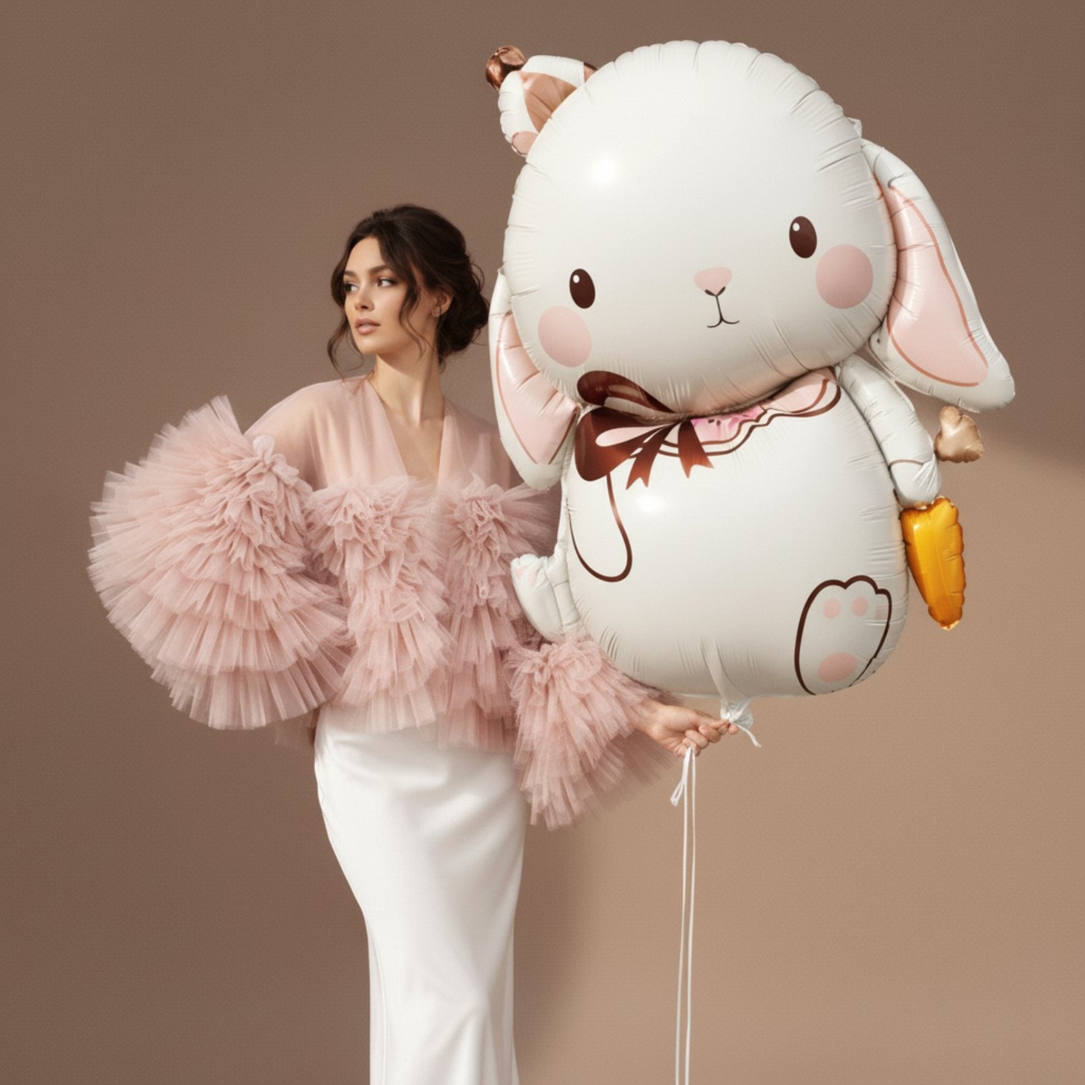 model holding oversized bunny helium balloon for birthday celebration