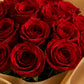 Detail of red rose bouquet in gold paper by AIWA Flowers Dubai
