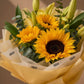 Close-up of sunflowers and lily buds by AIWA Flowers Dubai