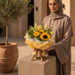 Woman holding a sunflower and lily bouquet by AIWA Flowers Dubai