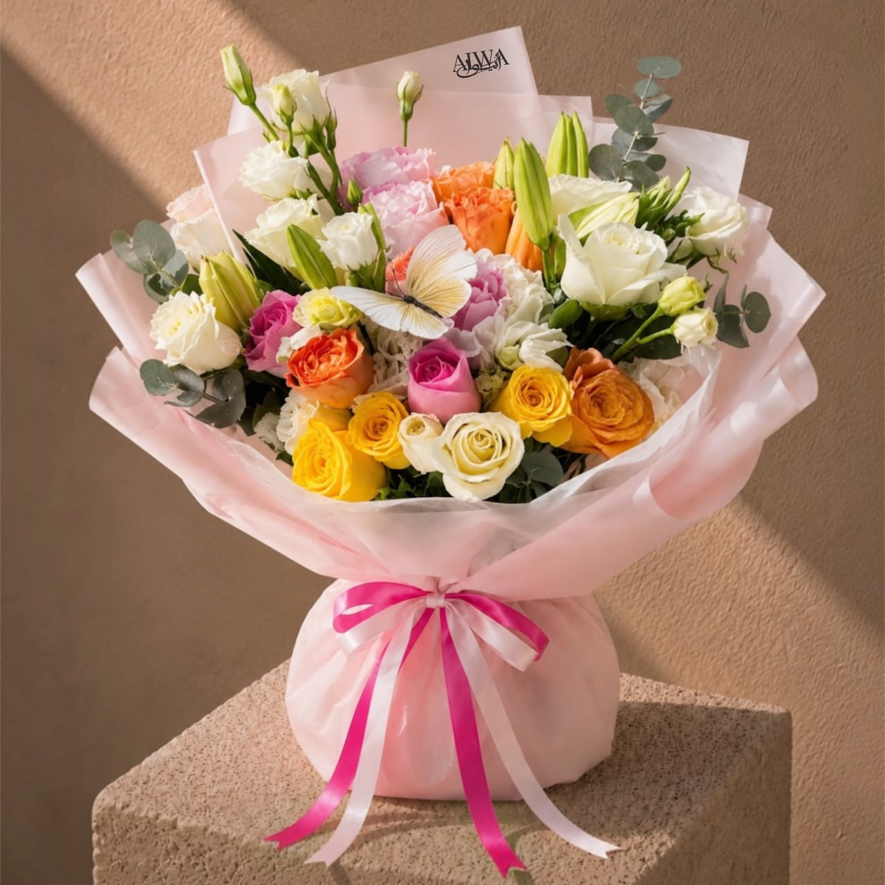 Multicolor rose and lily bouquet in pink wrap by AIWA Flowers Dubai