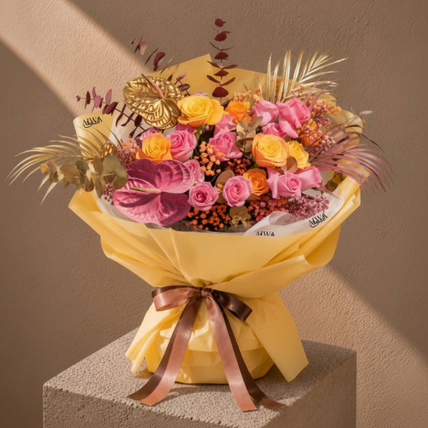 Pink, orange and yellow rose bouquet with gold anthurium by AIWA Flowers Dubai