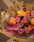 Close-up of pink roses and gold anthurium accents by AIWA Flowers Dubai