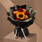 Sunflower, red and orange rose bouquet in black wrap by AIWA Flowers Dubai