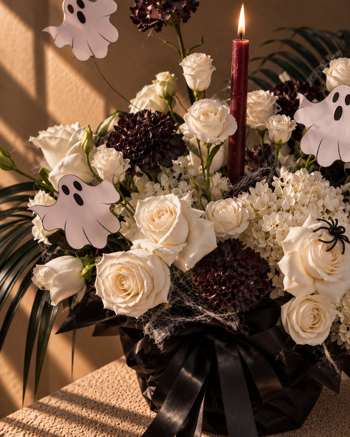 Close-up of white roses, hydrangea, black carnations and ghost picks in Ghostly Garden