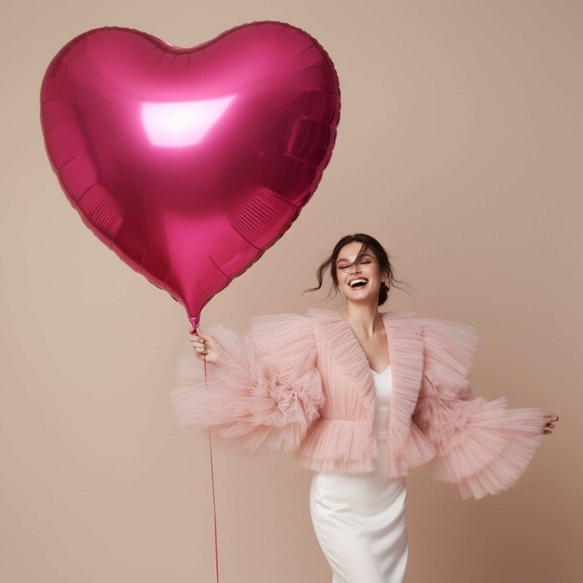 model holding giant pink heart helium balloon