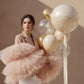 model holding gold pearl balloon set with transparent and beige balloons