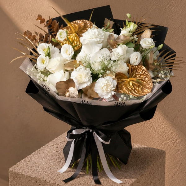 White and gold hand-tied bouquet by AIWA Flowers Dubai