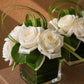 Grace white rose arrangement with green leaf lining in a clear glass cube by AIWA Flowers
