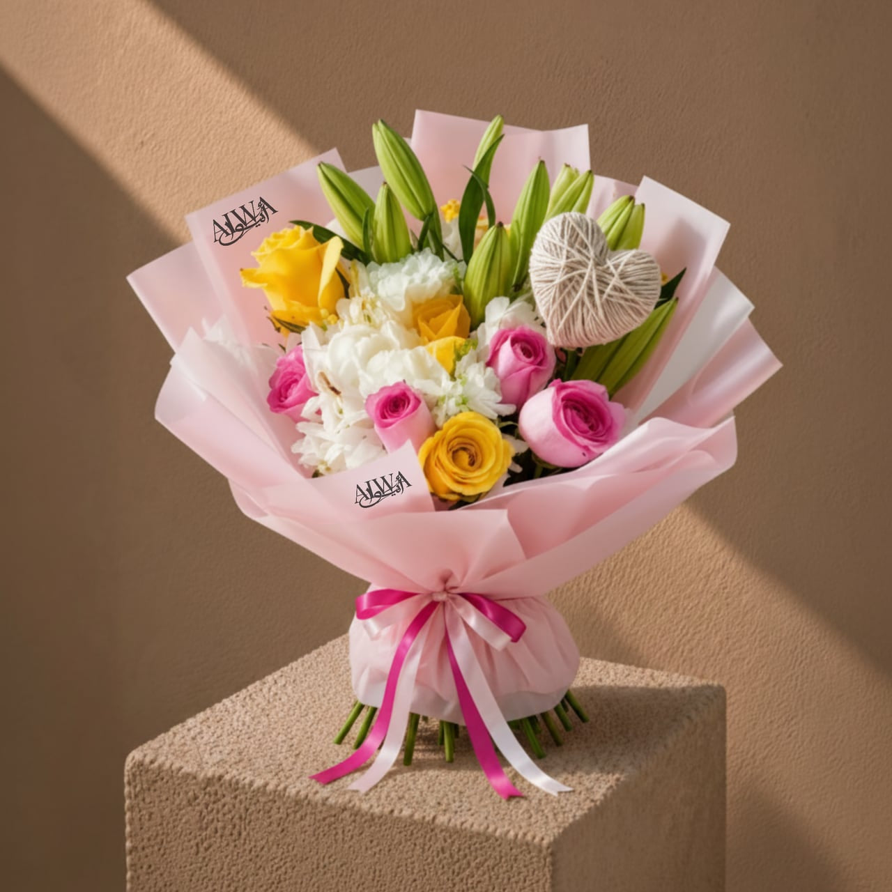 Pink and yellow rose bouquet with heart-knot accent by AIWA Flowers Dubai