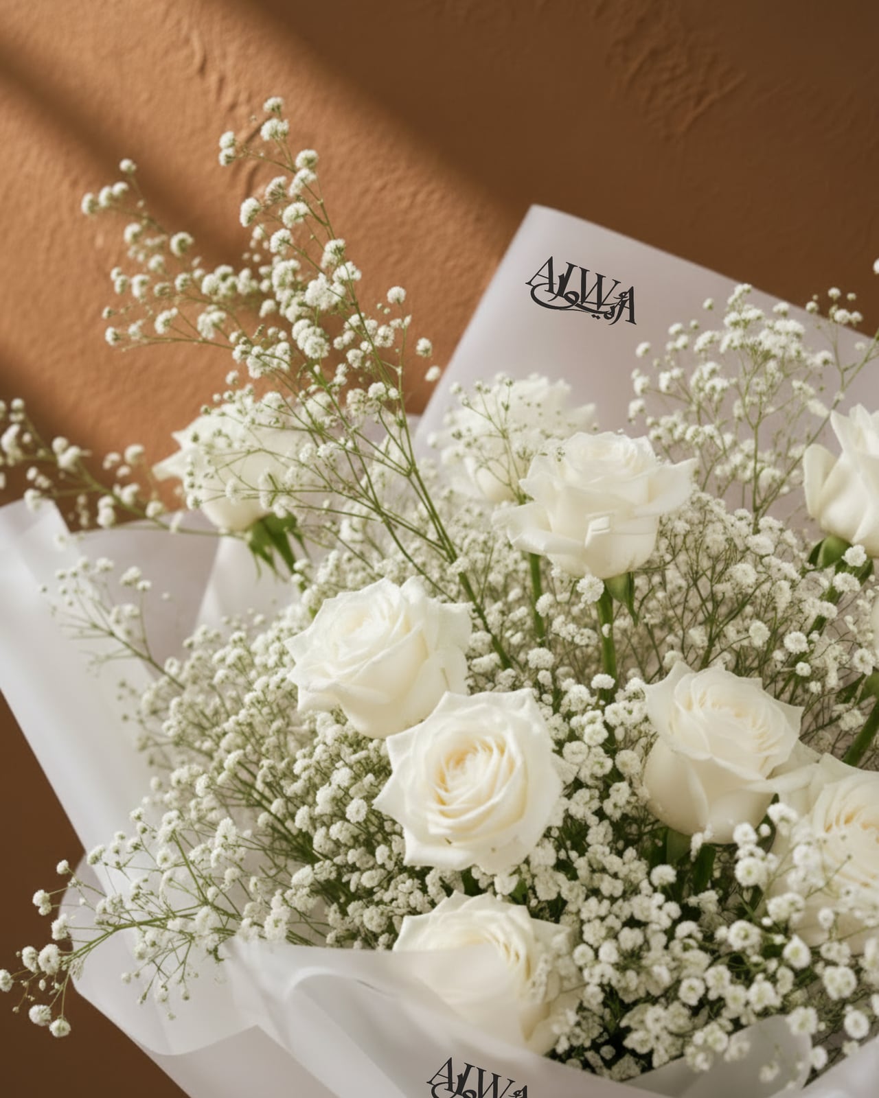 Close-up of white roses and gypsophila by AIWA Flowers Dubai