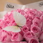 Close-up of pink roses with a white butterfly by AIWA Flowers Dubai