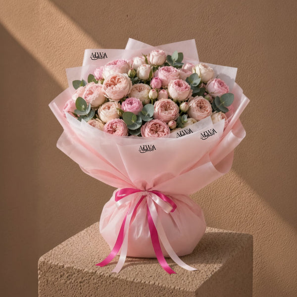Blush pink garden rose bouquet in pink wrap by AIWA Flowers Dubai