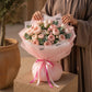 Woman holding a blush pink garden rose bouquet by AIWA Flowers Dubai