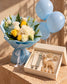 It's a Boy Hamper with white and yellow rose bouquet in blue wrap, baby-blue balloons and a baby gift box by AIWA Flowers Dubai