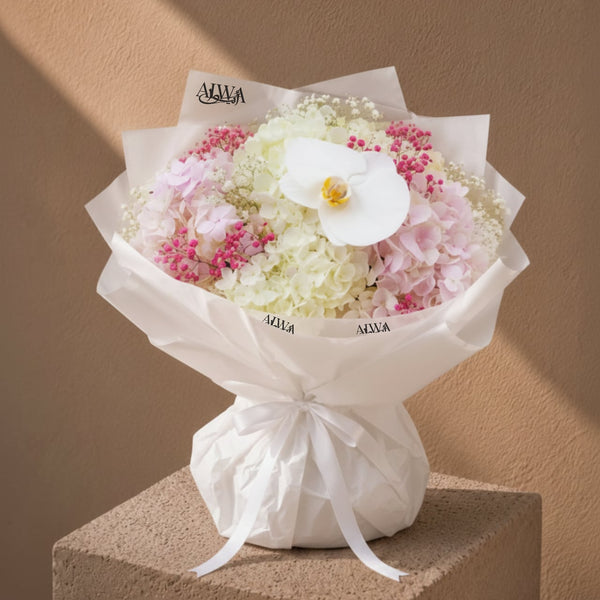 Ivory hydrangea and orchid bouquet in white wrap by AIWA Flowers Dubai