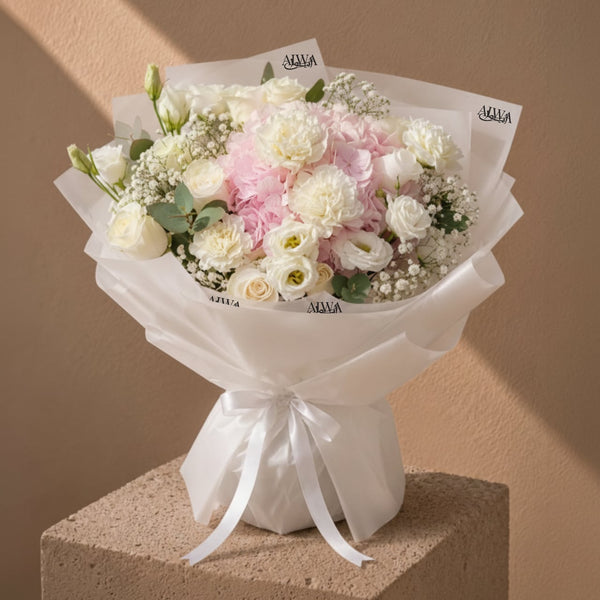 White rose and pink hydrangea bouquet in white wrap by AIWA Flowers Dubai