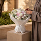 Woman holding a white and pink hydrangea bouquet by AIWA Flowers Dubai