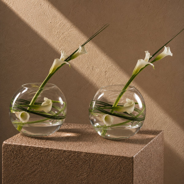 Two Laura white calla lily clear glass bowl arrangements styled on a plinth by AIWA Flowers