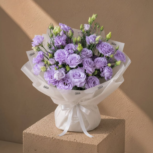 Purple lisianthus bouquet in white wrap by AIWA Flowers Dubai